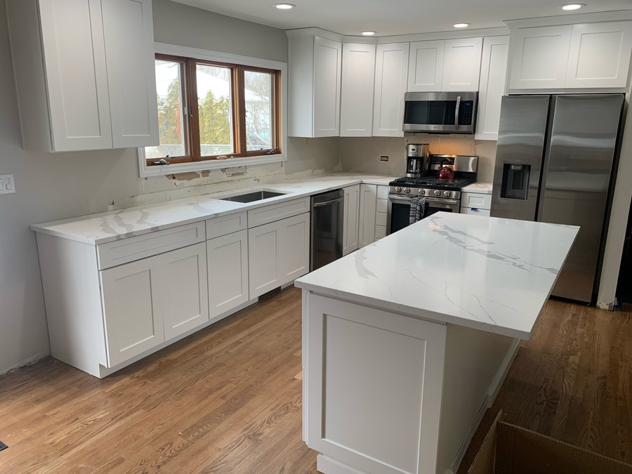White kitchen remodel with large marble island in Chicagoland