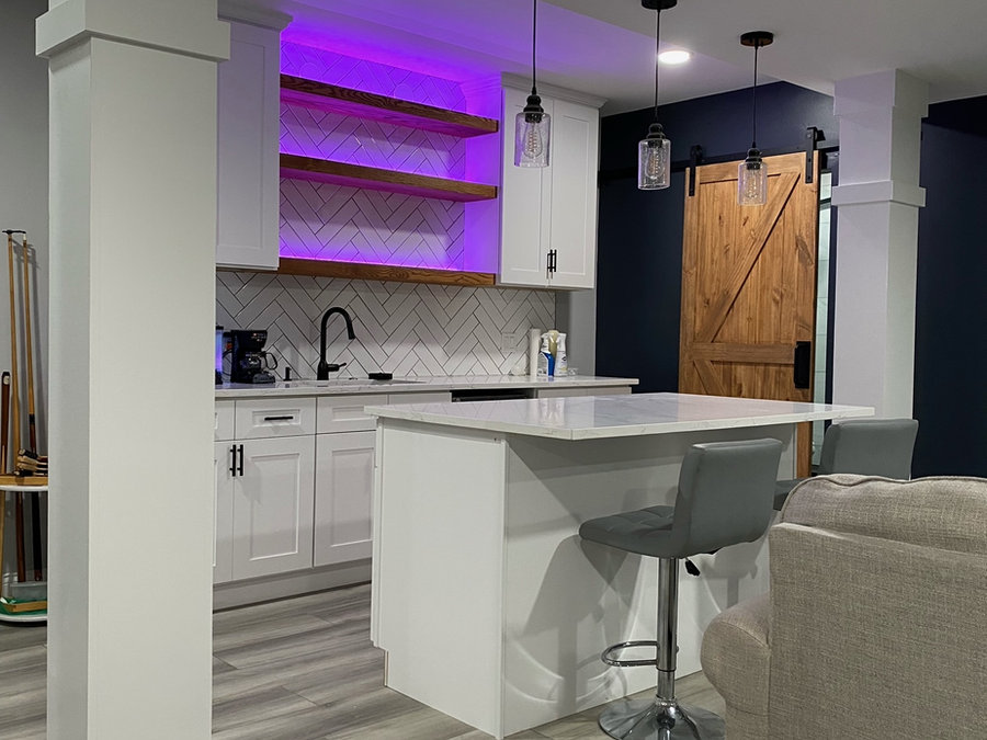 Basement kitchenette with island and custom shelving